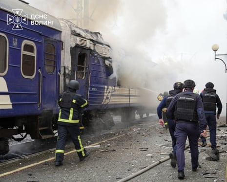 Firefighters extinguish fire at a train carriage damaged by a drone strike near the border with Poland.
