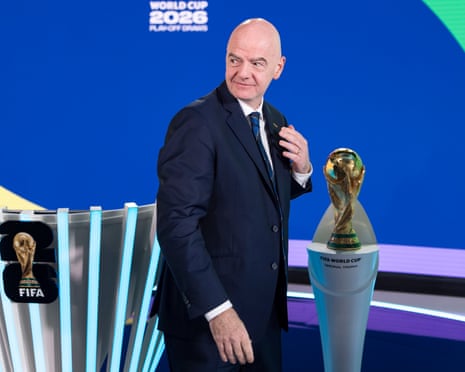 Fifa president Gianni Infantino stands next to the World Cup
