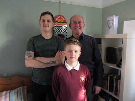 Robbie at home in his bedroom with his father and son