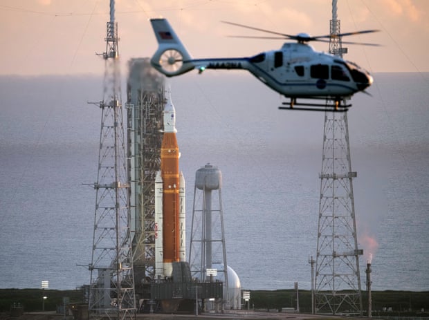 A Nasa helicopter flies past the agency’s Space Launch System (SLS) rocket with the Orion spacecraft aboard atop the mobile launcher at the Kennedy Space Center in Cape Canaveral, Florida.