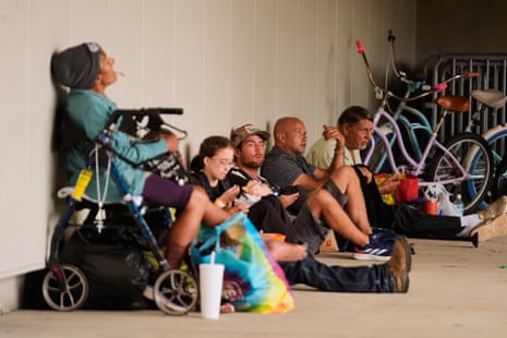People sit outside an evacuation shelter on Friday as Hurricane Isaias approaches Pensacola, Florida.