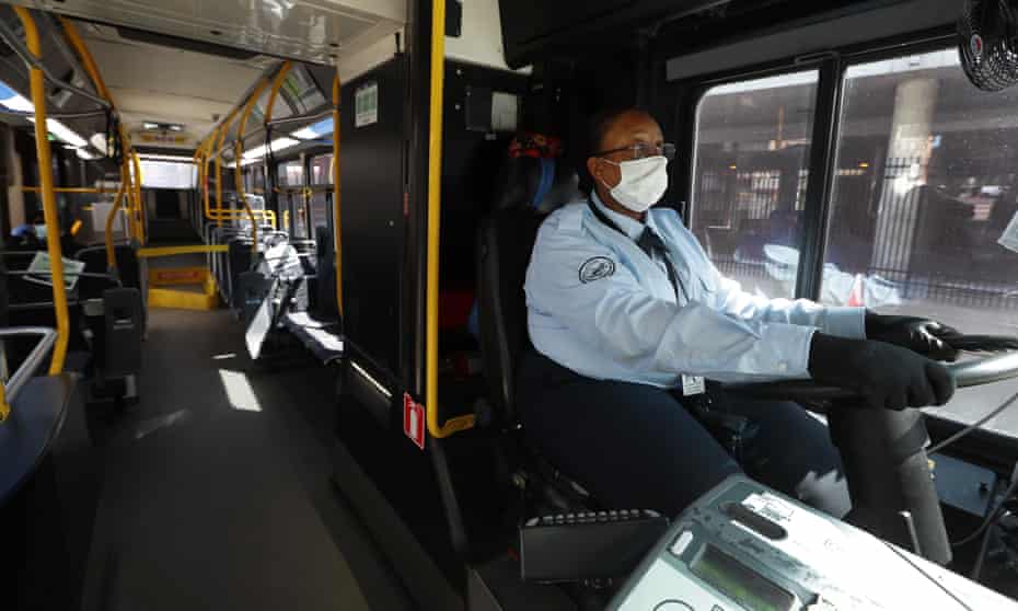 JaVita Brown, a Detroit bus driver, wears gloves and a mask while driving her route during the Covid-19 outbreak.