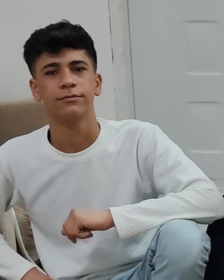 A teenager in a cream jumper looks at teh camera.