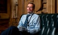 MP Craig Mackinlay in Westminster, sitting on a sofa and smiling at the camera. He has two prosthetic hands