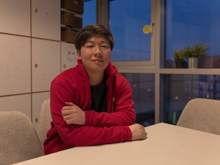 Sven Li, a student, sitting in his university kitchen.