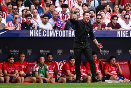 Diego Simeone stands in front of his substitutes