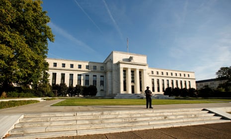 A police officer keeps watch in front of the U.S. Federal Reserve in Washington.