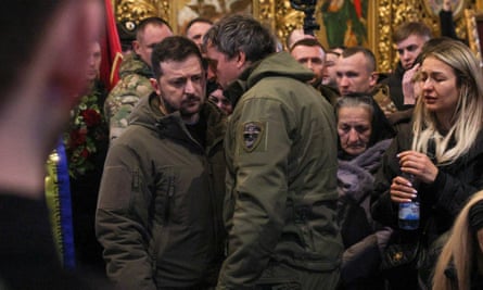 Volodymyr Zelenskiy, left, at the memorial service for Dmytro Kotsyubaylo.