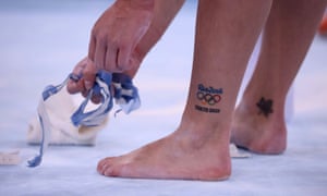 A Canadian gymnast shows off their tattoos.