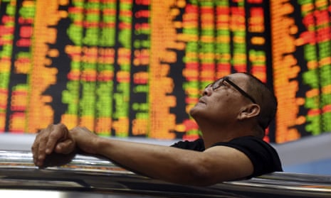 An investor watches shares fall at a stock market in Kuala Lumpur, Malaysia, on Thursday.