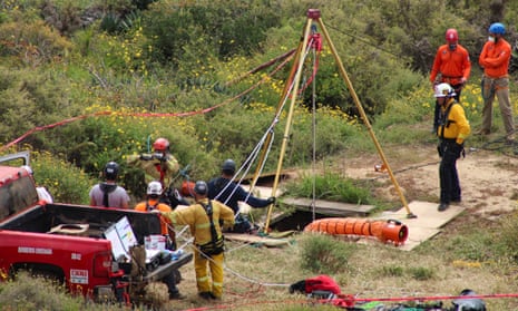 Members of a rescue team work at the well