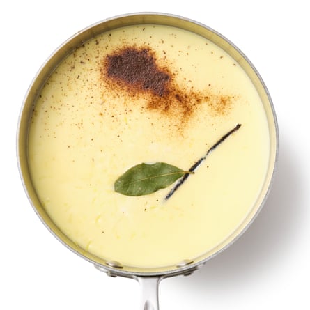 Felicity Cloke's Rice Pudding 05a. Here we pour in the milk and stir until the rice is semi-translucent ... on the surface there is nutmeg, cinnamon and bay leaf.