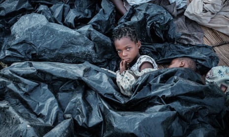 Children sleeping under sheets of plastic in Buzi, Mozambique