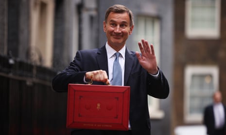 Jeremy Hunt smiles for the camera as he leaves Downing Street with his red briefcase