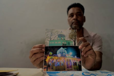 Riyasat Ali with a photograph of Thapli Baba shrine, which was demolished last year by authorities in Uttrakhand.