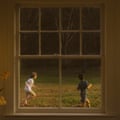 The album artwork for The Great Divide, depicting two young boys playing in a garden, seen through a paned window