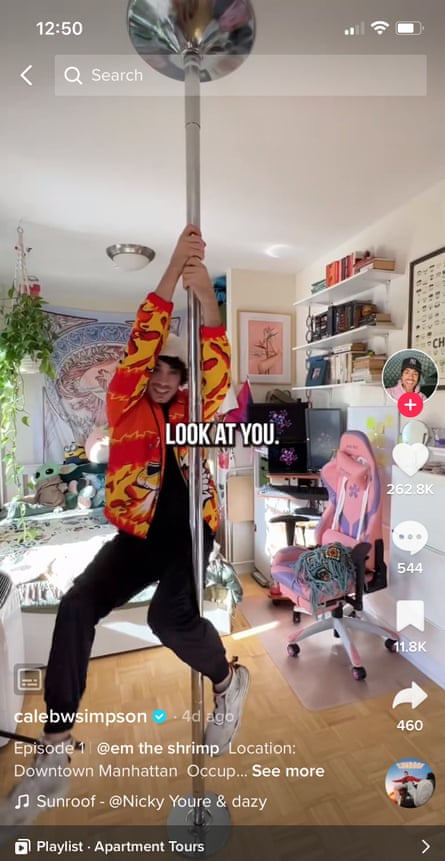 A person hanging from a striped pole in an apartment.