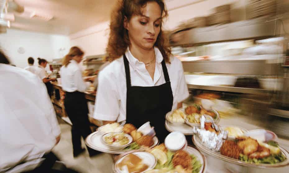 Waitress carrying plates of food