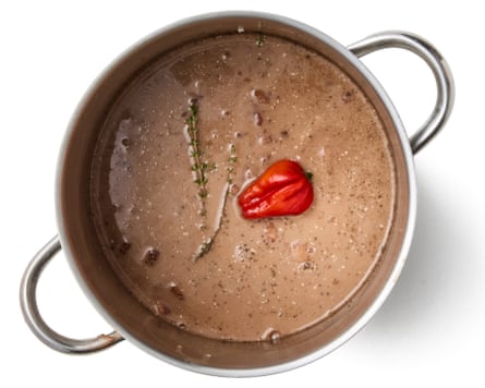 coconut milk, thyme, a whole chilli and allspice added to the pan