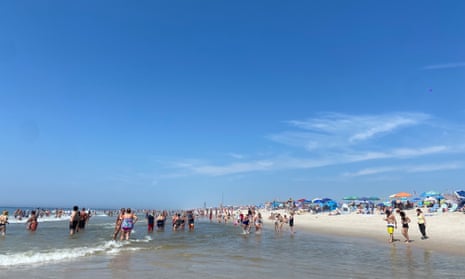 Beachgoers venture into the shallows at Robert Moses Beach in Long Island, New York.
