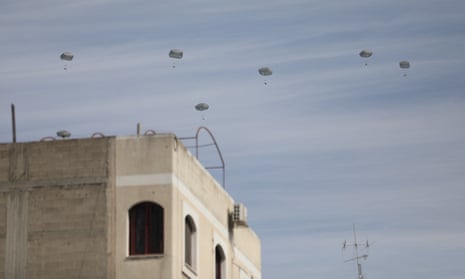 Humanitarian aid packages dropped from the air by Jordanian army planes are seen floating in the sky above Gaza City on 1 March.