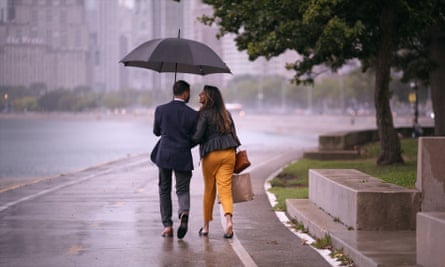 A still from the show showing a couple walking in the rain