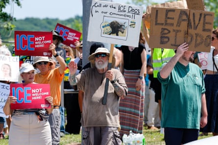 people holding signs such as ‘leave Biddo’ ‘call off the ICE dogs in our communities!!’ and ‘ICE not welcome here!’