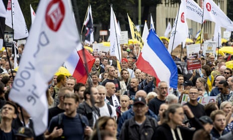 Protesters with banners and a Netherlands flag.