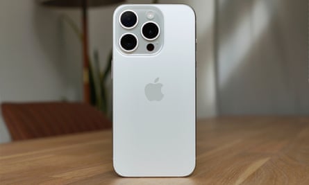 The back of the iPhone 15 Pro stood up on a table.