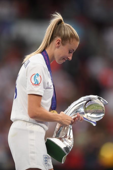 The Lionesses’ captain, Leah Williamson, carries the Women’s Euro 2022 trophy at Wembley