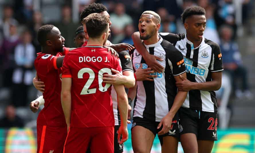 Newcastle’s Joelinton and Liverpool’s Diogo Jota clash during a tightly contested first half