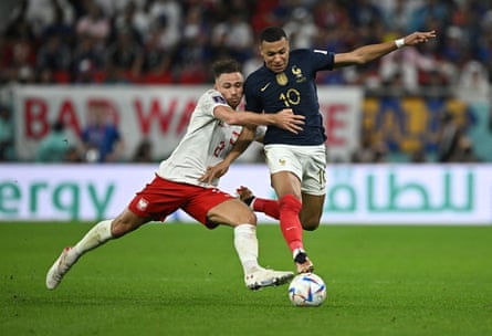 Matty Cash does his best in action against Kylian Mbappé.