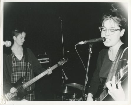 A black and white film photograph of Heavens to Betsy playing live