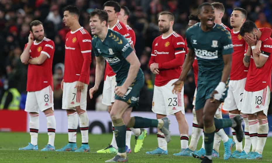 Manchester United players show their disappointment as Middlesbrough players celebrate winning the penalty shoot-out which means they’re through to the fifth-round.