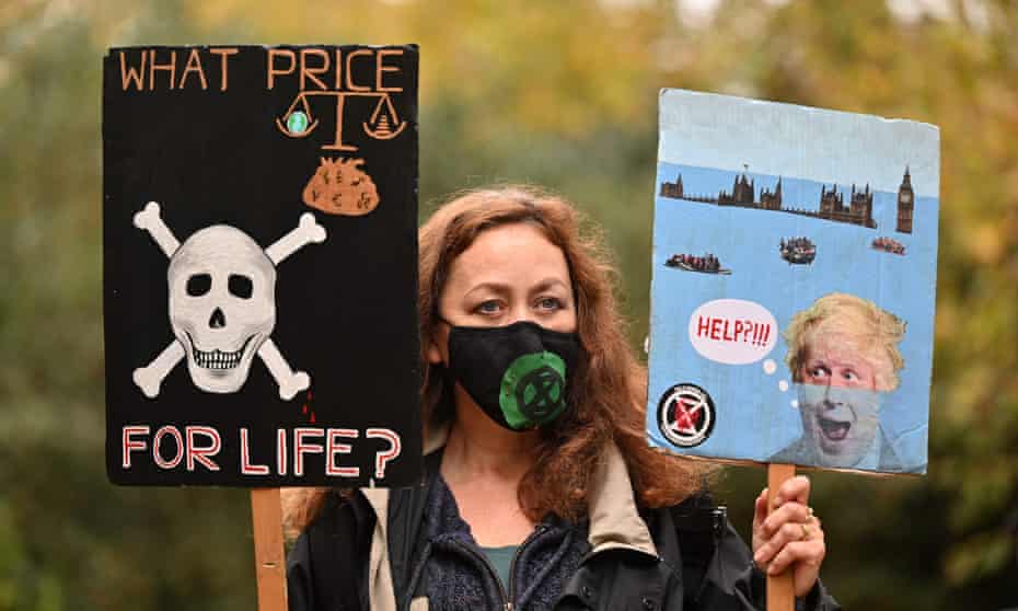 A climate activist with a placard portraying a skull
