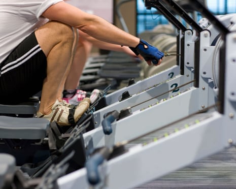 Man working out on rowing machine in health club