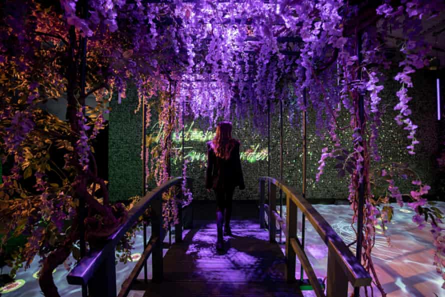 A staff member on a garden bridge at the opening day of the Monet’s Garden exhibition at the Alte Muenze, Berlin. The exhibition, which will run in Berlin until March, offers an immersive experience into the works of the French 19th century painter.