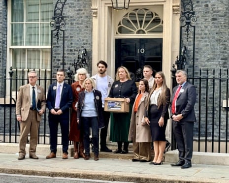 Ten family members of the victims of the 1994 RAF Chinook crash stand outside No 10 Downing Street.