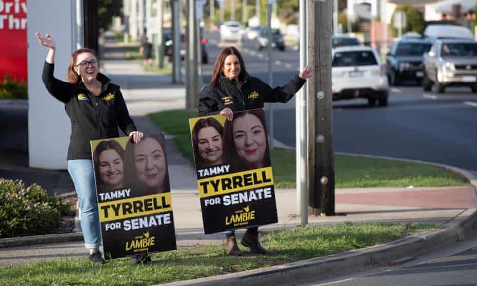 Jacqui Lambie and her network Senate candidate Tammy Tyrrell wave to traffic while campaigning in Devonport, Tasmania, Australia