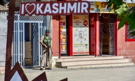 A paramilitary trooper stands guard during the G20 tourism meeting in Srinagar, India
