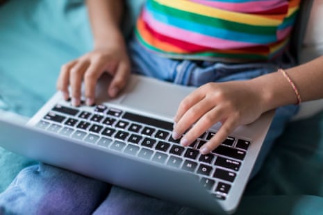 close up of hands using a laptop keyboard