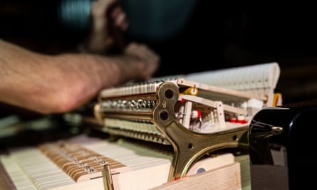 David Kinney, piano technical manager at the Sydney Conservatorium, works on a Steinway & Sons grand piano