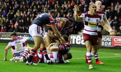 Thomas Leuluai of Wigan Warriors protests to the referee as the Sydney Roosters celebrates their side’s second try scored by Brett Morris.