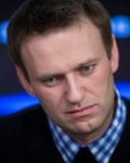 Head-and-shoulders closeup of Navalny looking thoughtful, with his head slightly tilted
