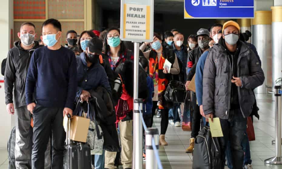 Passengers waiting to be screened at Jomo Kenyatta airport in Nairobi, Kenya, after arriving from China.