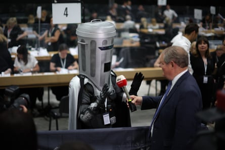 Count Binface talks to a reporter who is holding a microphone in front of him