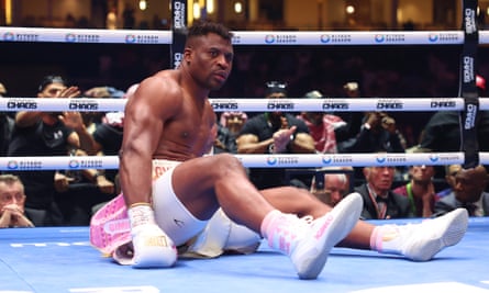 A stunned Francis Ngannou reacts after being knocked down by Anthony Joshua.