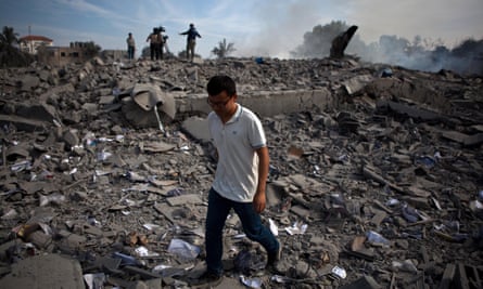 Chen Xu walks through the ruins of a building in the Gaza Strip after it was levelled by an Israeli airstrike in November 2012.