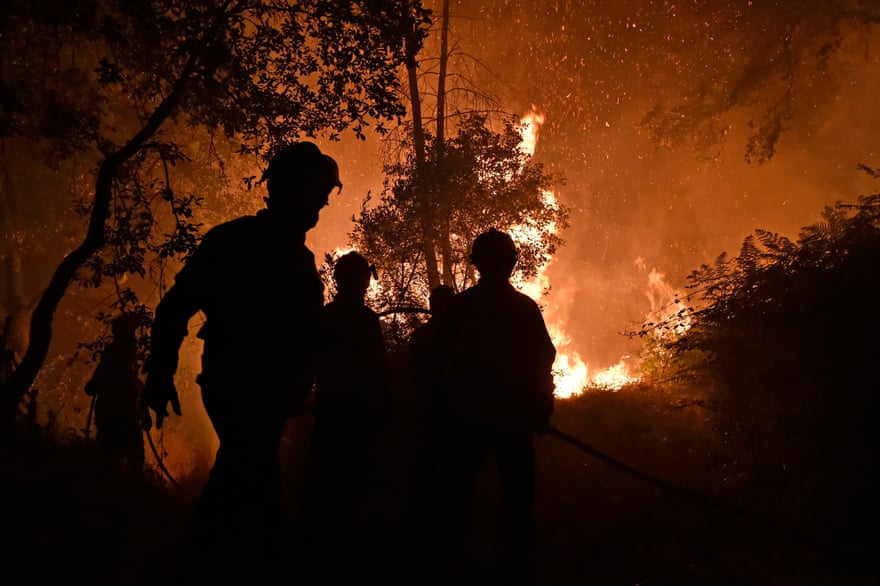 Firefighters in action as a wildfire burns near the village of Barracao, in the municipality of Leiria, Portugal, 13 July 2022. The fire forced authorities to close highway n. 1 in both directions.