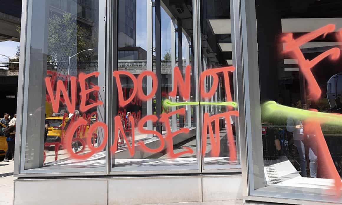 A Tesla showroom window in Manhattan tagged with ‘WE DO NOT CONSENT.’